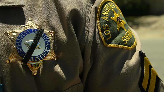 An Officer with the Los Angeles County Sheriff's Department who knew Sorensen wears a black band ove 