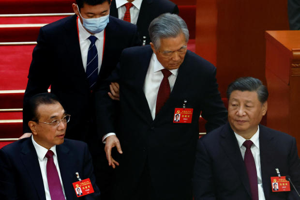 Former Chinese President Hu Jintao leaves his seat next to Chinese President Xi Jinping and Premier Li Keqiang during the closing ceremony of the 20th National Congress of the Communist Party of China at the Great Hall of the People in Beijing, China, Oct 