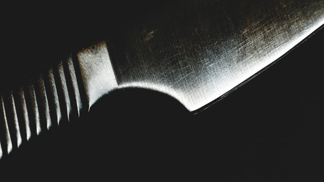 Steel kitchen knife on black background 