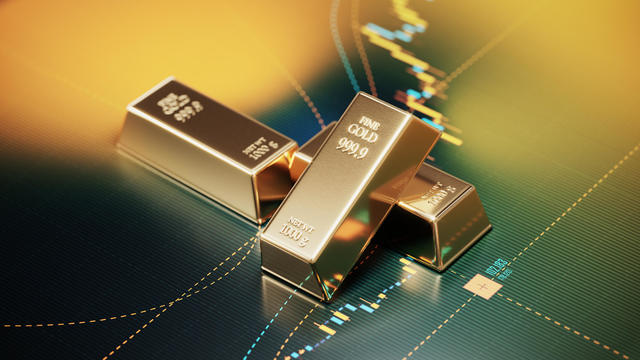 Gold Bars Sitting over A Bar Graph - Stock Market and Finance Concept 