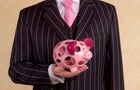 Banker/financial advisor with holey piggy bank 