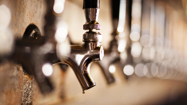 Close-up of metallic beer taps at bar 