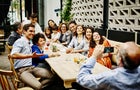 Man taking family portrait in restaurant 