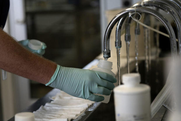 A scientist collects water to test for chemical contamination 