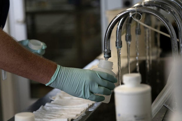 A scientist collects water to test for chemical contamination