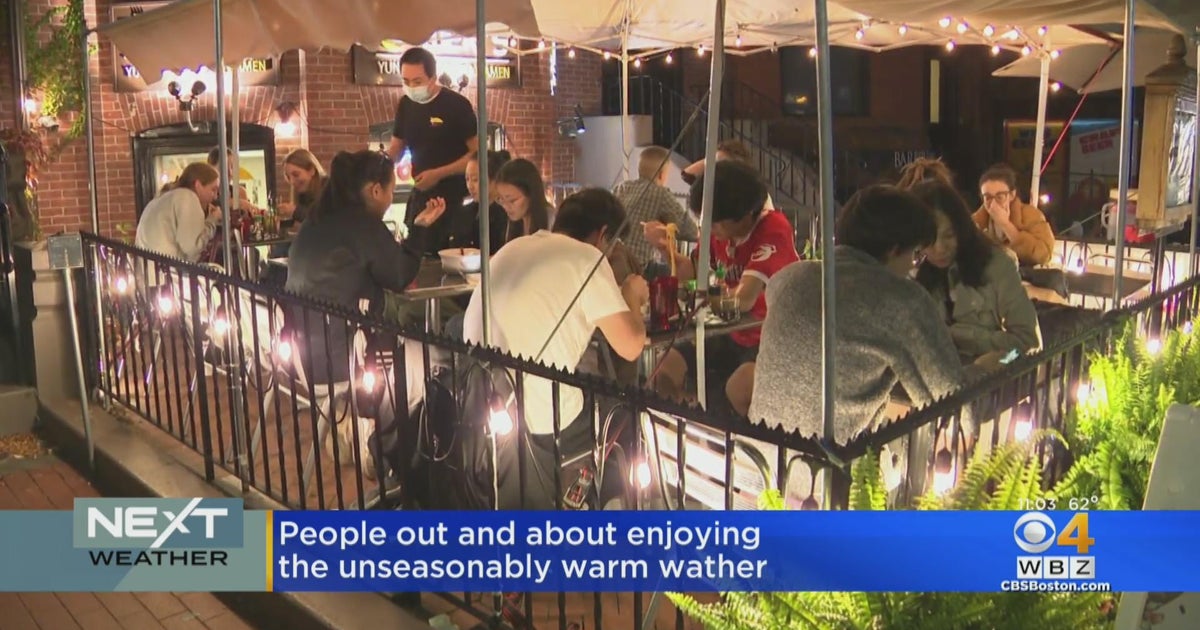 Outdoor dining, Topgolf at Fenway packed with people enjoying warm