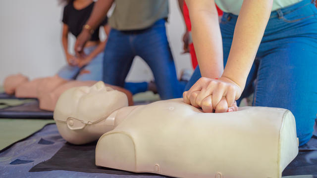 Hands Of A trainee doing chest compression during defibrillator CPR Training. 