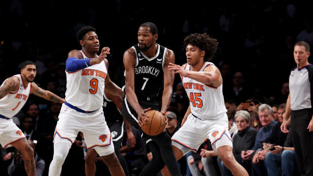 Kevin Durant #7 of the Brooklyn Nets looks to pass against RJ Barrett #9 and Jericho Sims #45 of the New York Knicks during their game at Barclays Center on November 09, 2022 in New York City. 