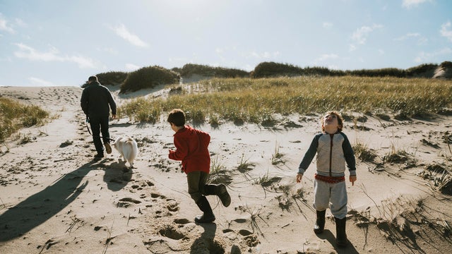 Family with dog on sand dune 