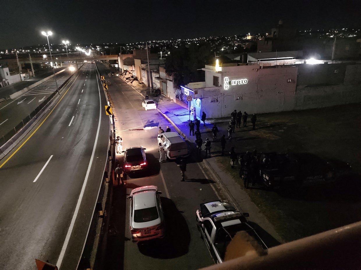 Forensic technicians work at a crime scene at a bar in Apaseo El Alto 