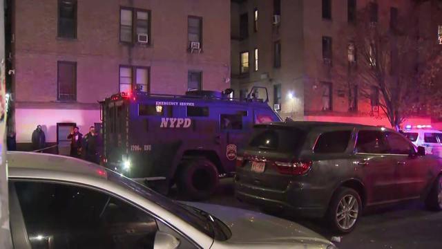 An NYPD emergency service vehicle sits outside an Inwood apartment building. 