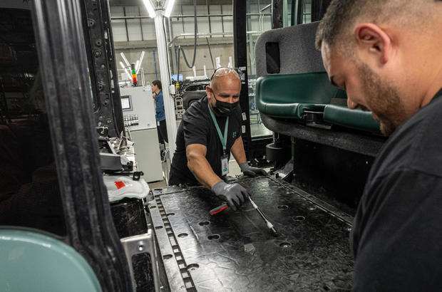 Engineers work on a Zoox Inc., autonomous vehicle at the company's manufacturing facility in Fremont, California, U.S., on Thursday, April 7, 2022. Zoox is a subsidiary of Amazon developing autonomous vehicles that provide Mobility-as-a-Service. 