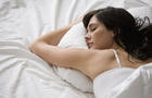 Caucasian woman sleeping in bed 
