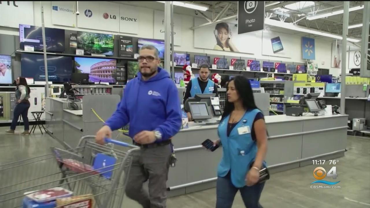 Man shopping at Walmart getting assistance from an employee