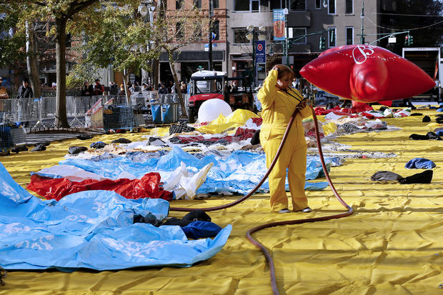 A woman holds a hose during the Macy's Thanksgiving Day Parade balloon inflation on November 23, 2022 in New York City. 
