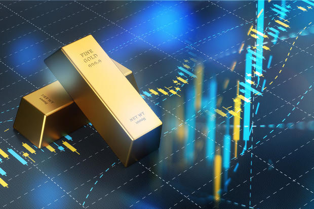 Gold Bars Sitting on Blue Bar Graph, Stock Market and Finance Concept. 