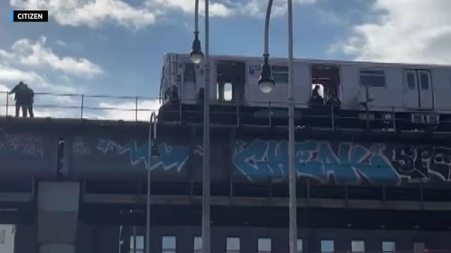 Police investigate a stopped subway car on the Williamsburg Bridge. 