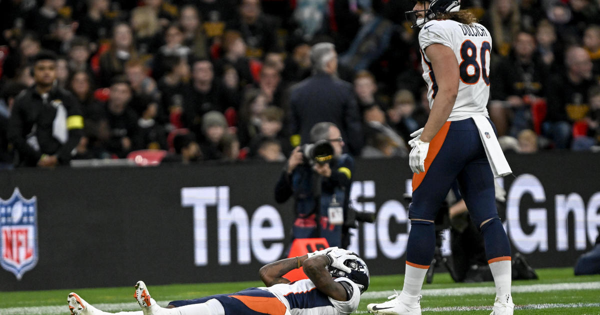 Greg Dulcich of the Denver Broncos stands on the field during the News  Photo - Getty Images