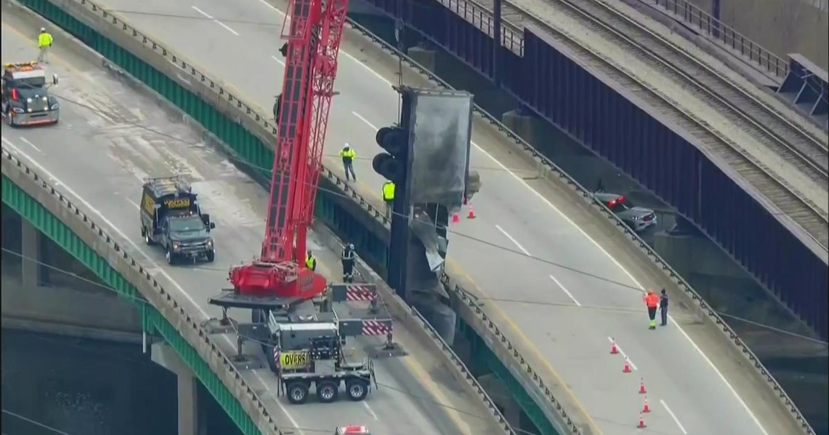 UPS Semi-truck goes off bridge, catches fire