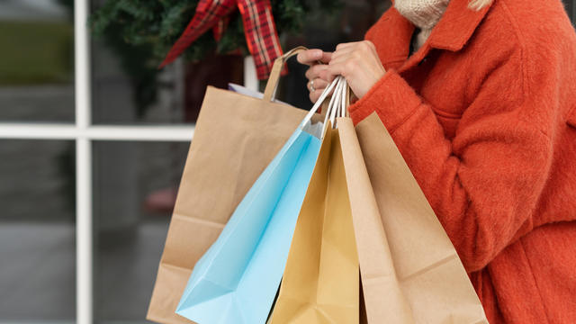 Close-up of a woman carrying shopping bags at Christmas 