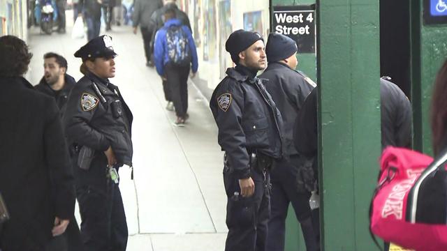 NYPD officers stand on the platform at the West 4th Street subway station. 