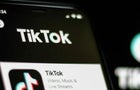 In this photo illustration a TikTok logo seen displayed on a 