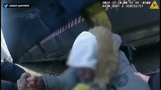 Body cam video from an NYPD officer shows two officers pulling a man up from subway tracks onto the platform. 