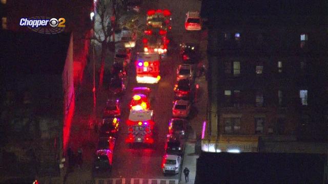 An aerial view of several emergency response vehicles parked on a Bronx street. 