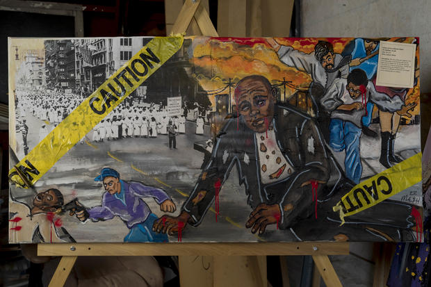 Mykael Ash's painting "Marching Through Oppression" depicts the East St. Louis race riot of 1917 