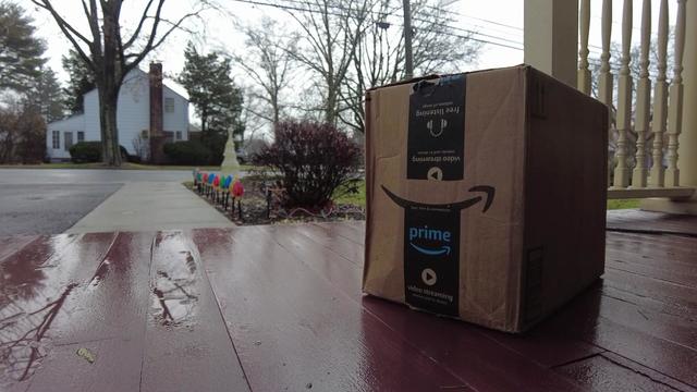 An Amazon package sits on a porch. 