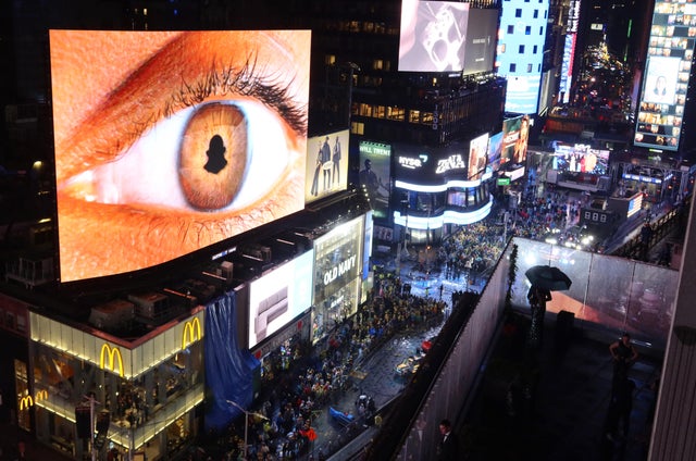 Revelers stand in the rain as they celebrate New Year's Eve in Times Square on December 31, 2022, in New York City. 
