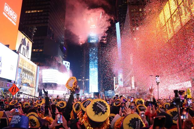 Onlookers watch as confetti fills the air to mark the beginning of the new year, in Times Square, New York City, on January 1, 2023. 