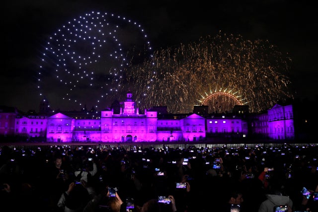 People record a drone depiction of Britain's late Queen Elizabeth II during New Year's celebrations, in central London, Britain, January 1, 2023.