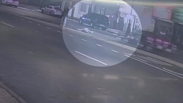 Surveillance video shows a man lying in the street as a car approaches. 