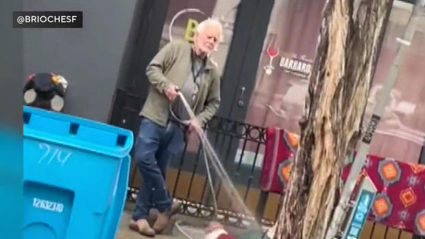 Art gallery owner sprays homeless woman with hose 