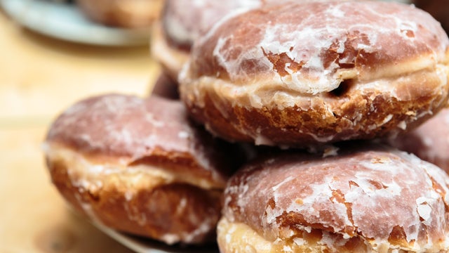 Brown "Paczki" Donuts on White Plate. 