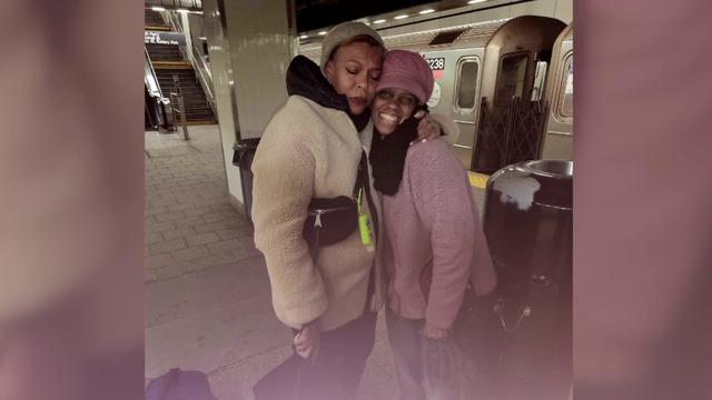 Samantha Primus hugs someone at a subway station. 