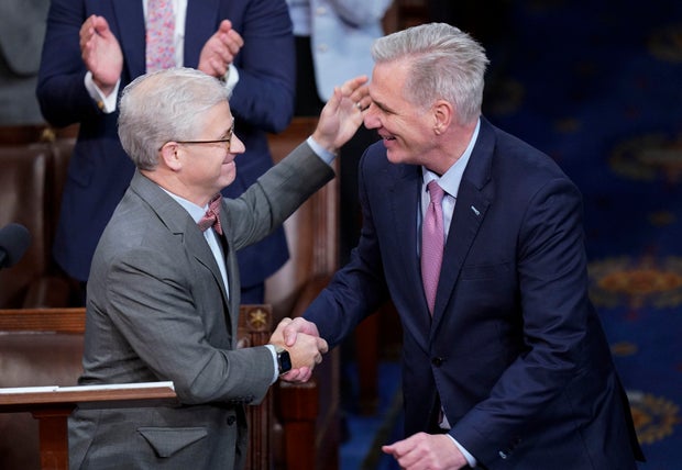 Rep. Kevin McCarthy shakes hands with Rep. Patrick McHenry after McHenry nominated him in the 14 round of voting for speaker on Friday, Jan. 6, 2023.