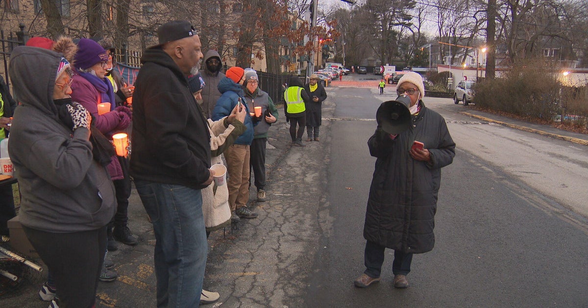 Residents at "SoMa At The T" apartment complex in Mattapan hold rally
