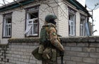 A Ukrainian soldier observes the situation near the northern 