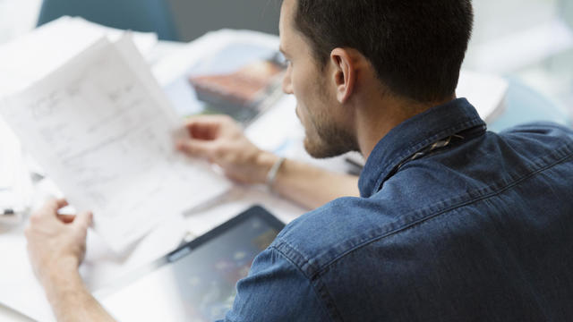 Man going over invoices in office 