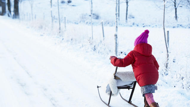 Girl pushing kick sled 