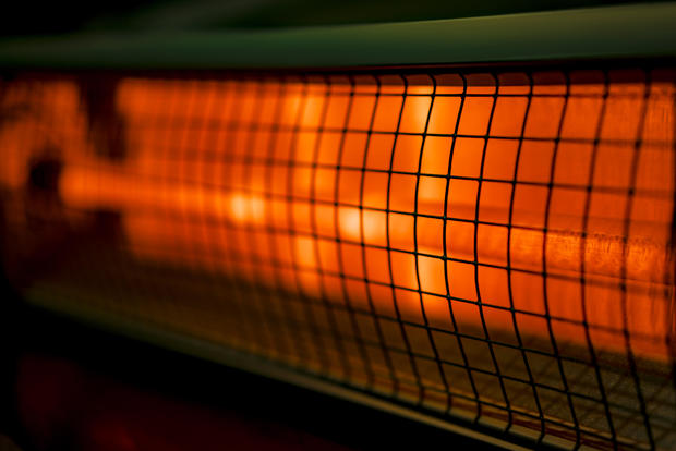 Close up of portable electric halogen heater on black background 