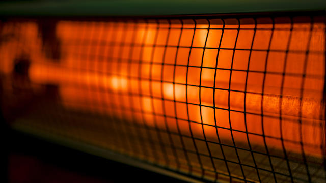 Close up of portable electric halogen heater on black background 