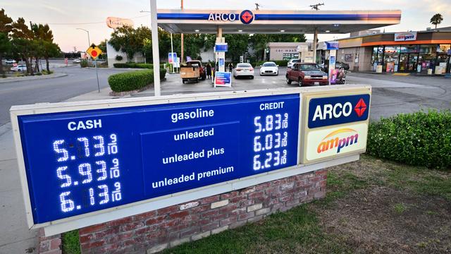 Gas prices listed on a sign show $5.73 a gallon for regular gas, $6.13 for unleaded premium 