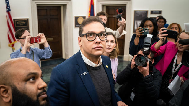 Reporters surround embattled Congressman George Santos, a Republican from New York, as he heads to the House chamber for a vote, at the U.S. Capitol on Jan. 31, 2023, in Washington. 