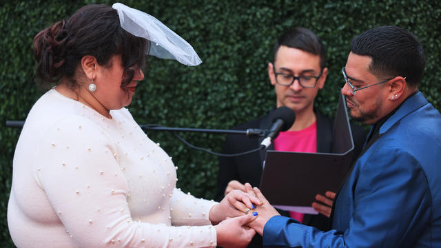Kristen LaBoy and Jesus Torres participate in a wedding officiated by fashion designer Christian Siriano in Times Square on February 14, 2023 in New York City. 