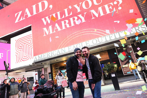 Zaid Kamousi and Gary Puhl celebrate after getting engaged during Valentine's Day in Times Square on February 14, 2023 in New York City. 
