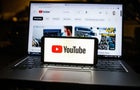 In this photo illustration a Youtube logo seen displayed on 