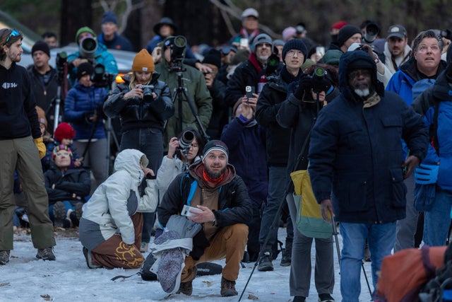 People look at the Horsetail Fall at Yosemite National Park in California 